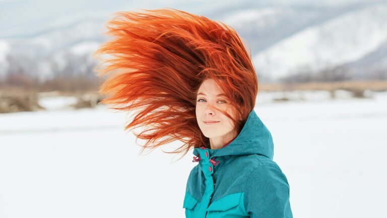 Winter haircut inspiration featuring long red hair and soft layered waves