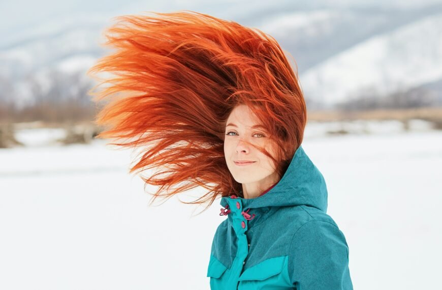 Winter haircut inspiration featuring long red hair and soft layered waves