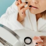 Woman applying lip balm during a cosy winter morning skincare routine