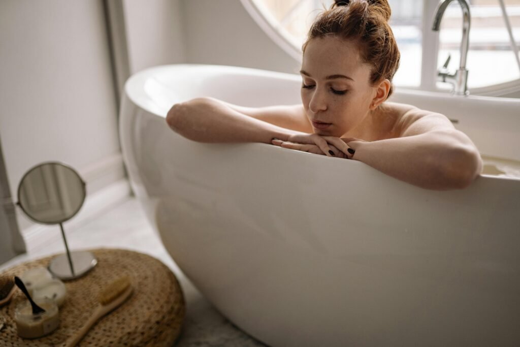 woman enjoying a calming bath as part of a full self-care routine