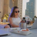 woman enjoying coffee living well without overspending