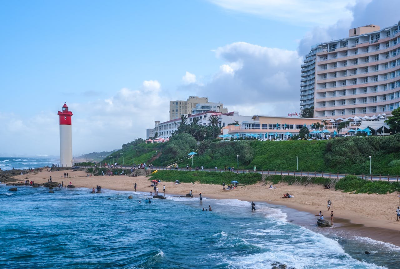 Luxury Umhlanga travel guide featuring Umhlanga Beach, the iconic red-and-white lighthouse, oceanfront hotels, and stylish coastal views in South Africa